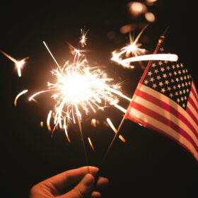 American flag and sparkler celebrating America 250 and July 4th — Flag World Company, Colorado