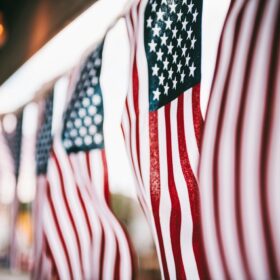 American flags lining a railing as patriotic home decorations in Colorado