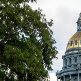 US and Colorado flags flying at the Colorado State Capitol for the Colorado 150th anniversary
