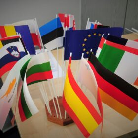 Miniature international stick flags in a desktop stand ready for classroom flags activities and show and tell