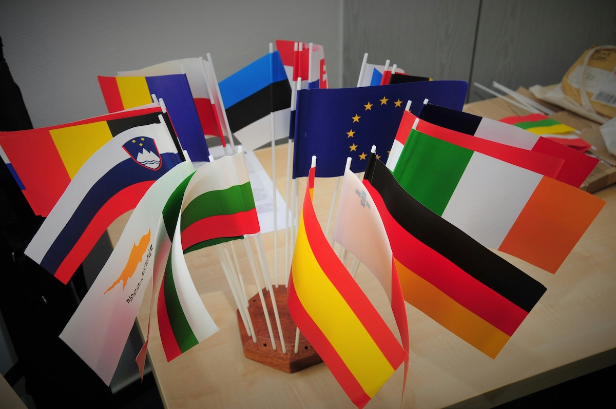Miniature international stick flags in a desktop stand ready for classroom flags activities and show and tell