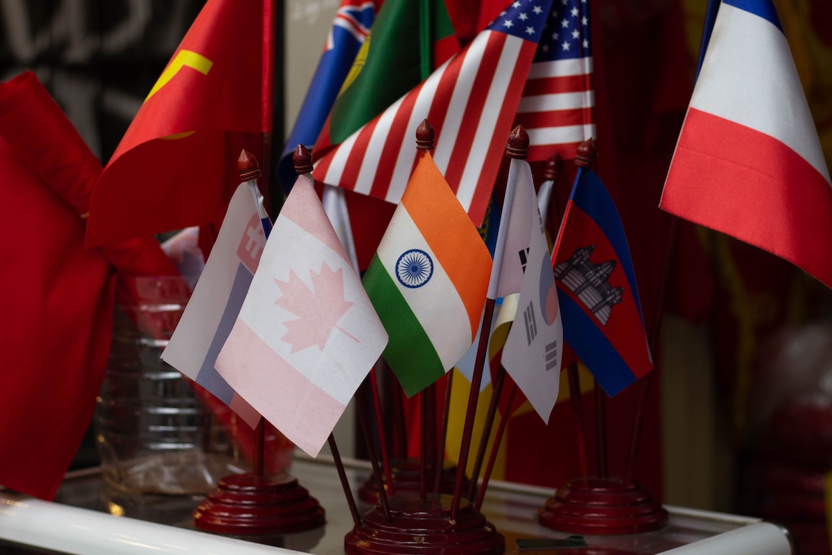 Small country desk flags on wooden bases including India, Korea and Canada