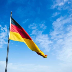 The German flag flying against a blue sky, for Oktoberfest and German-American heritage in Colorado