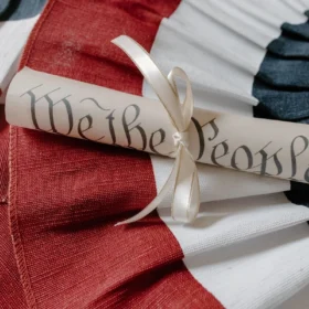 A "We the People" Constitution scroll resting on an American flag for Constitution Day