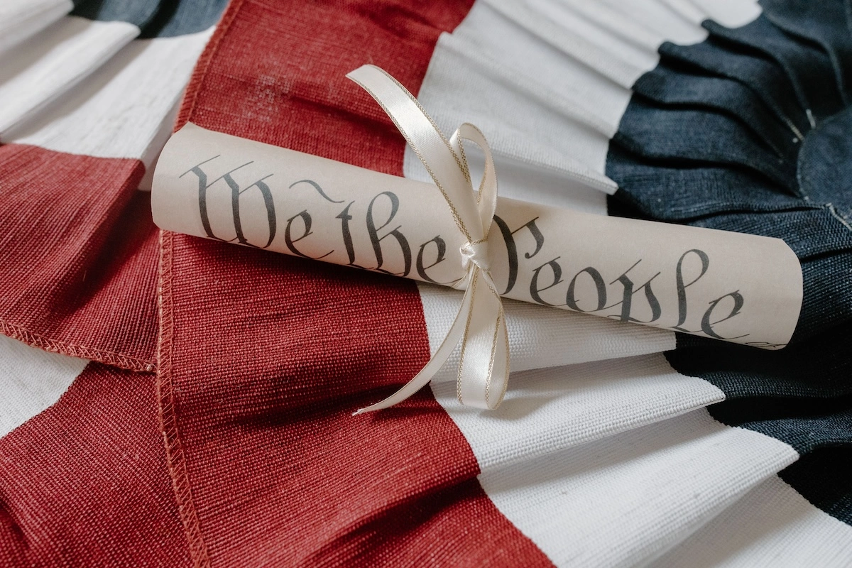 A "We the People" Constitution scroll resting on an American flag for Constitution Day