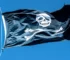 Black Jolly Roger skull-and-crossbones pirate flag flying against a blue sky — Halloween flags in Colorado