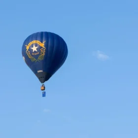 Nevada state flag with its silver star and Battle Born scroll on an outdoor pole