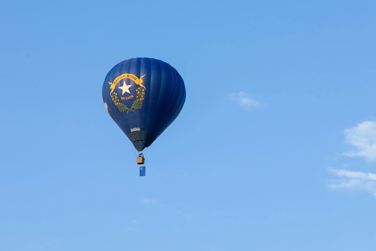 Nevada state flag with its silver star and Battle Born scroll on an outdoor pole